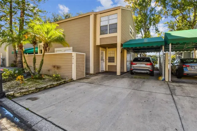 a view of a balcony with chairs and wooden fence