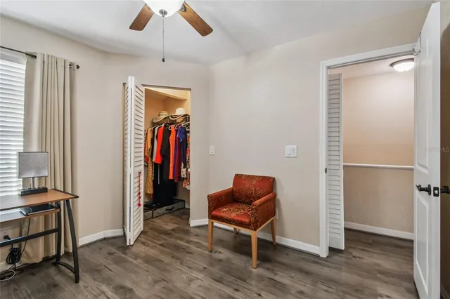 a balcony with table and chairs and potted plants