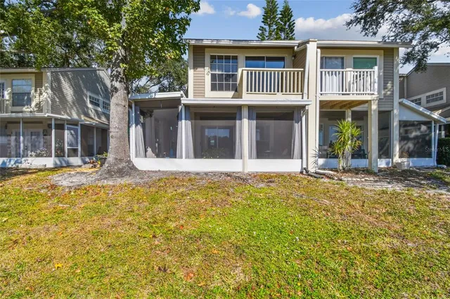 a view of swimming pool with seating space and trees