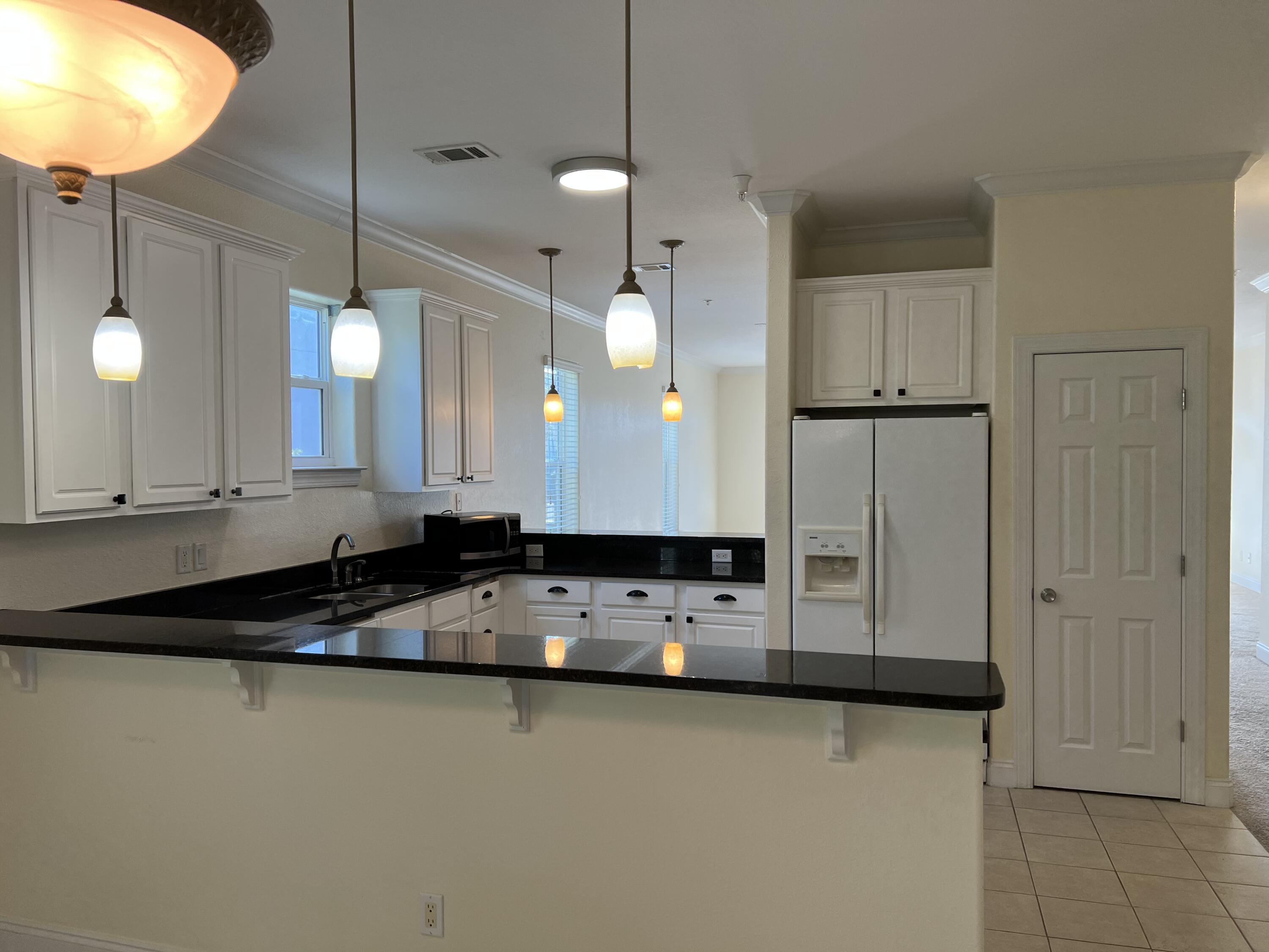 118 Spires Lane, Unit 5B Santa Rosa Beach, FL 32459 - Photo 12 of 28 a kitchen with stainless steel appliances granite countertop a sink a stove and a refrigerator