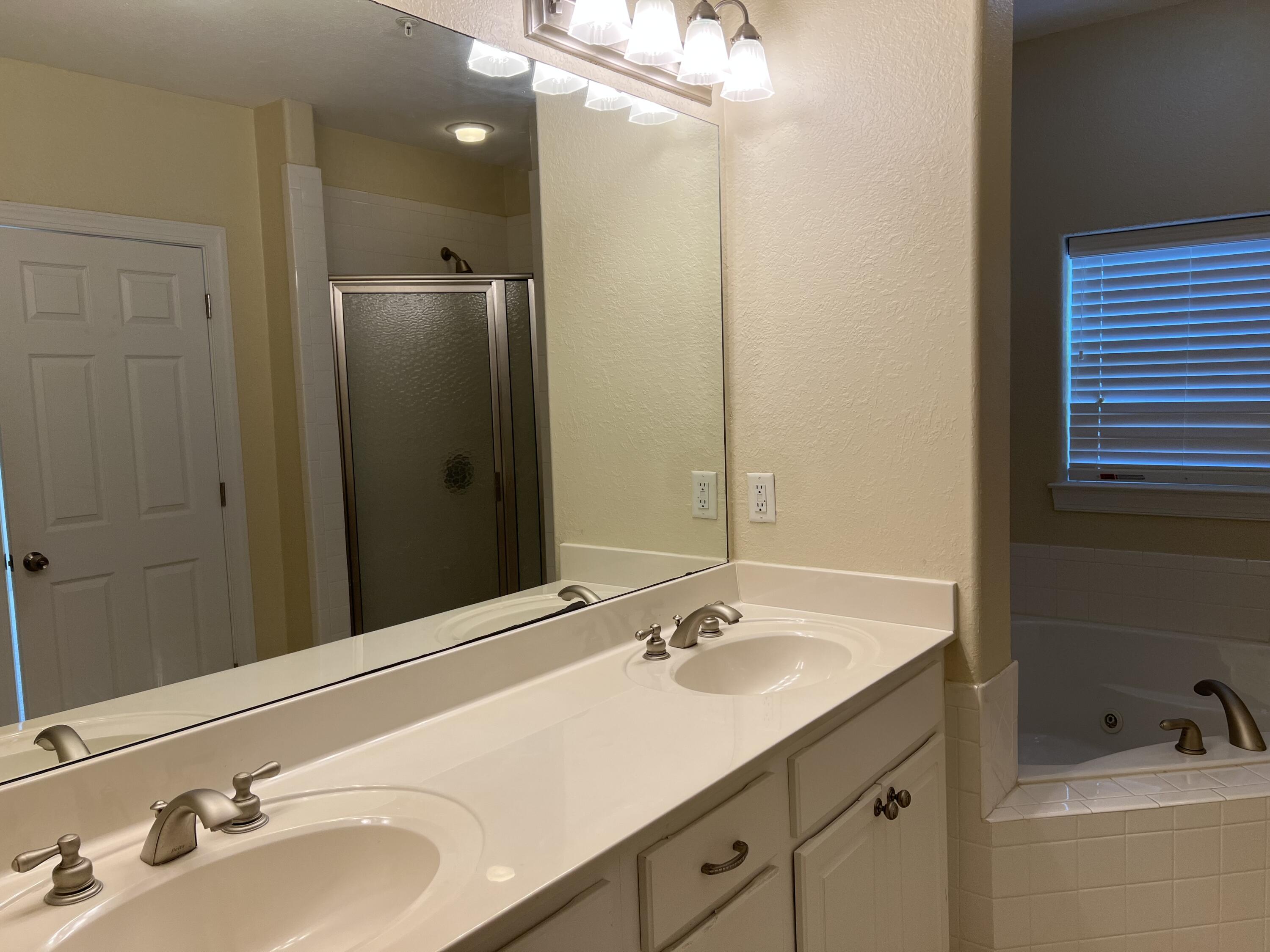 118 Spires Lane, Unit 5B Santa Rosa Beach, FL 32459 - Photo 20 of 28 a bathroom with a sink double vanity and a mirror