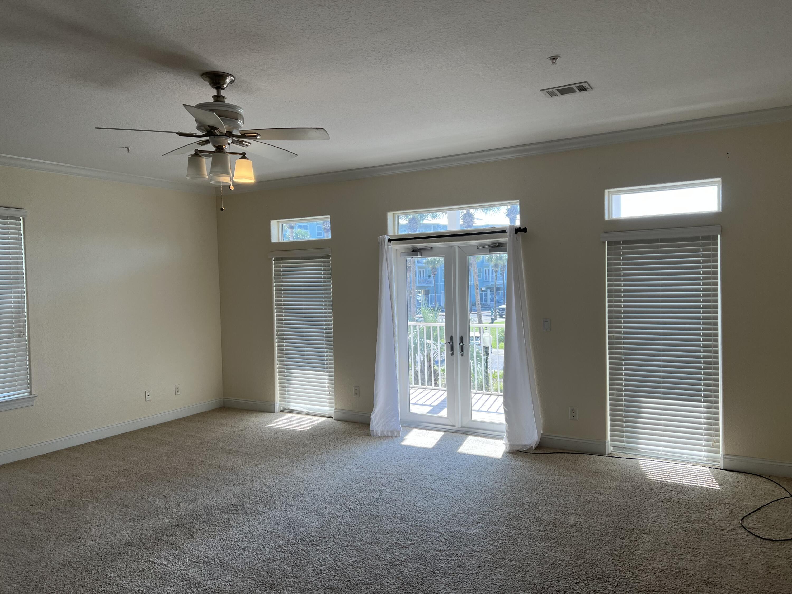 118 Spires Lane, Unit 5B Santa Rosa Beach, FL 32459 - Photo 6 of 28 a view of a livingroom with a ceiling fan and window
