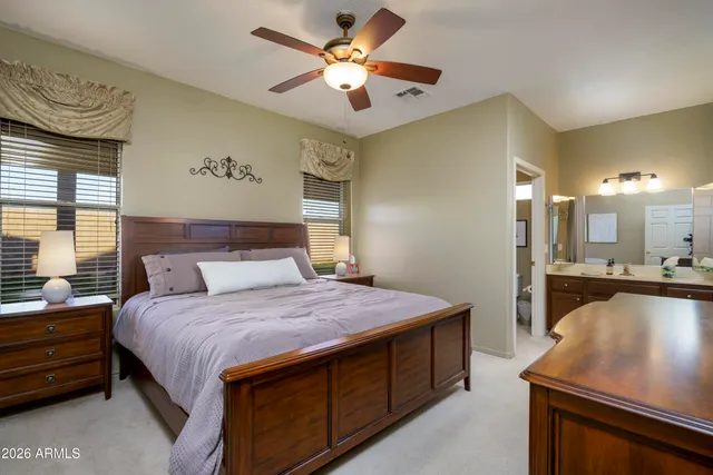 a bedroom with a large bed and dresser