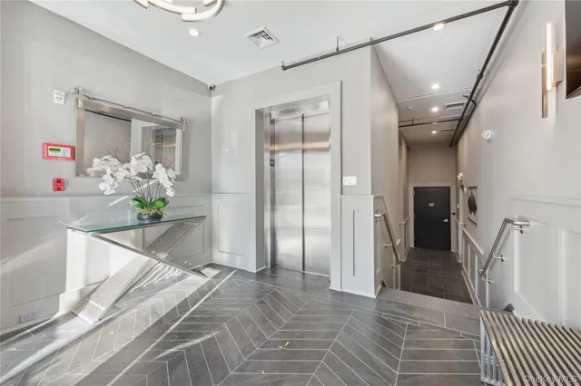 a spacious bathroom with a granite countertop sink a mirror and a shower