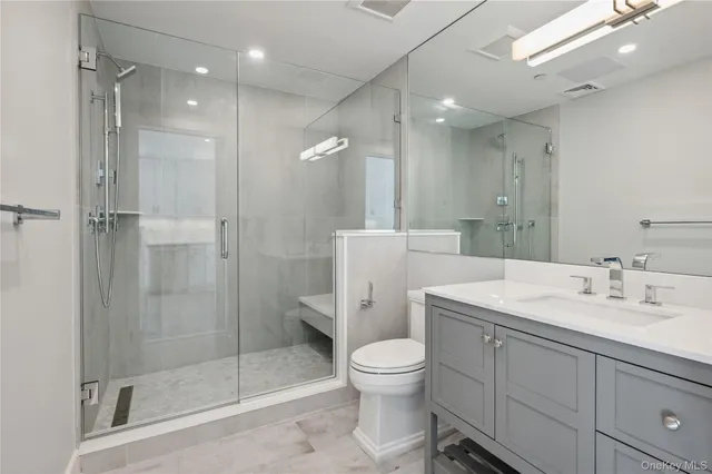 a bathroom with a toilet sink and shower