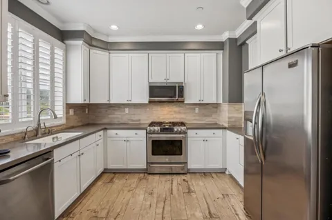 a kitchen with a white cabinets and refrigerator