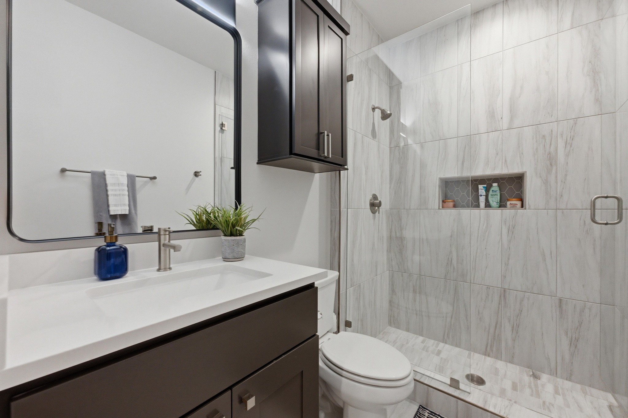 3905 Emory Peak Pass Austin, TX 78731 - Photo 18 of 40 a bathroom with a sink a toilet and shower