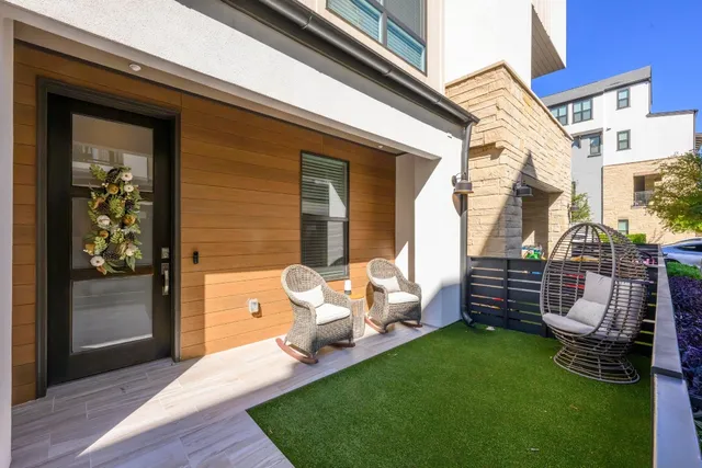 a view of a house with backyard and sitting area