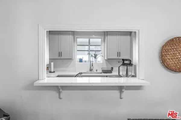 a kitchen with a sink cabinets and window