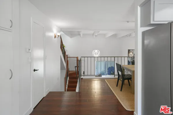 a view of entryway and hall with wooden floor