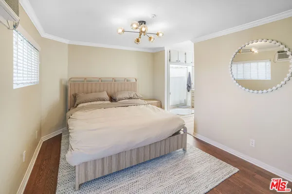 a bedroom with a bed and a mirror