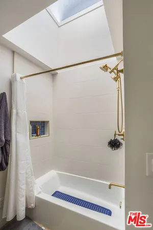a bathroom with a bathtub and a shower
