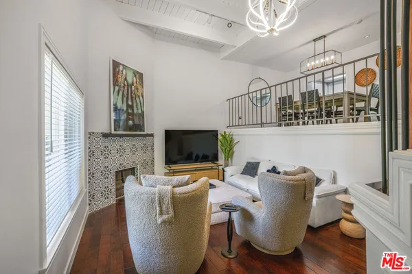 a view of a livingroom with furniture and a flat screen tv