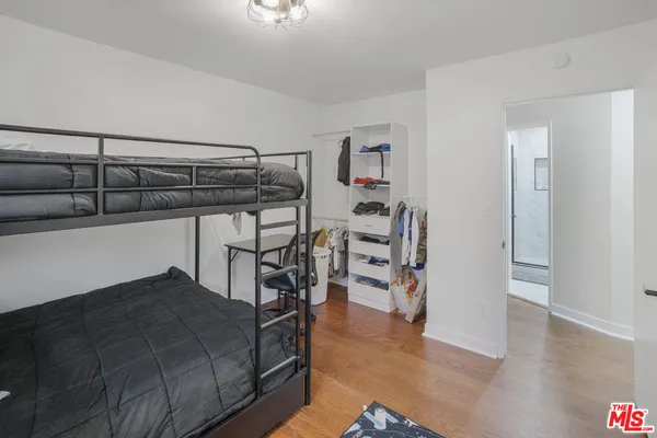 a bedroom with furniture and wooden floor