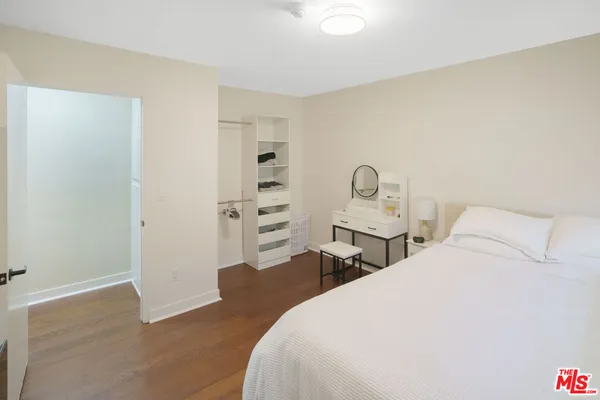 a bedroom with a bed and dresser