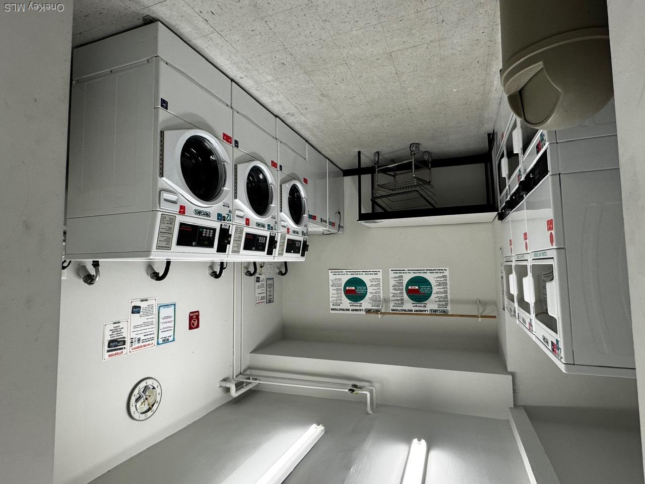 830 Shore Road, Unit 4M Long Beach, NY 11561 - Photo 19 of 20 Community laundry room with stacked washer and clothes dryer, light flooring, and washer and clothes dryer