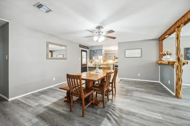 a view of a dining room with furniture and a chandelier