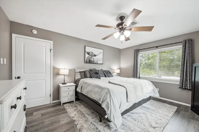 a spacious bedroom with a bed and a window
