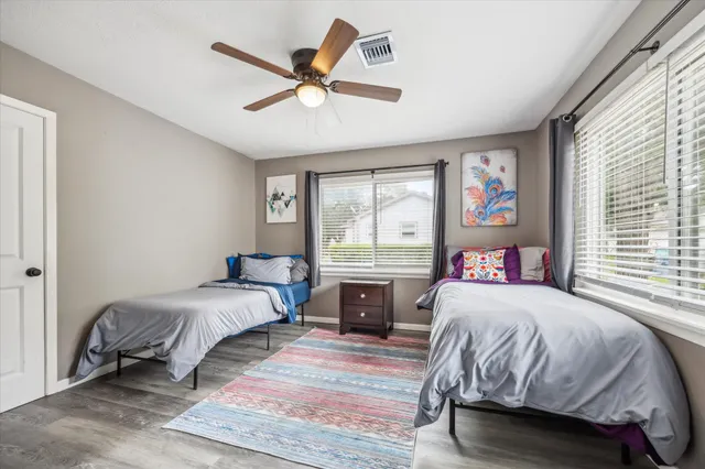 a bedroom with a large bed and a window