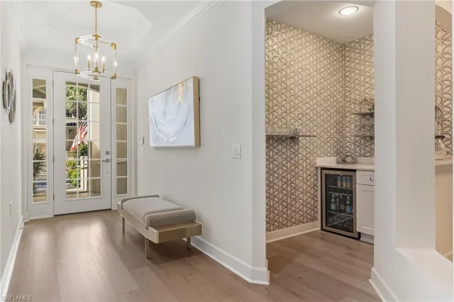 a living room with furniture and a chandelier