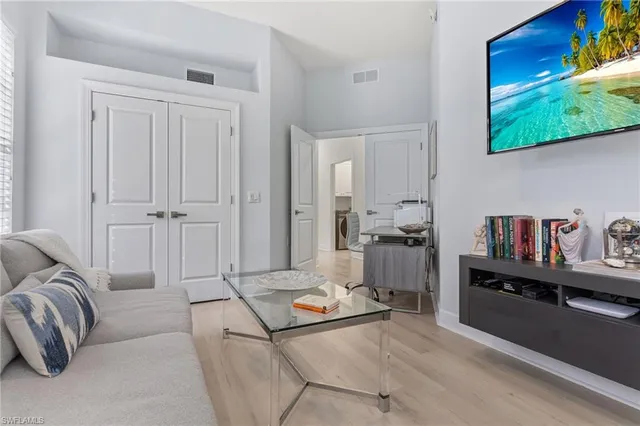 a living room with furniture and a bed