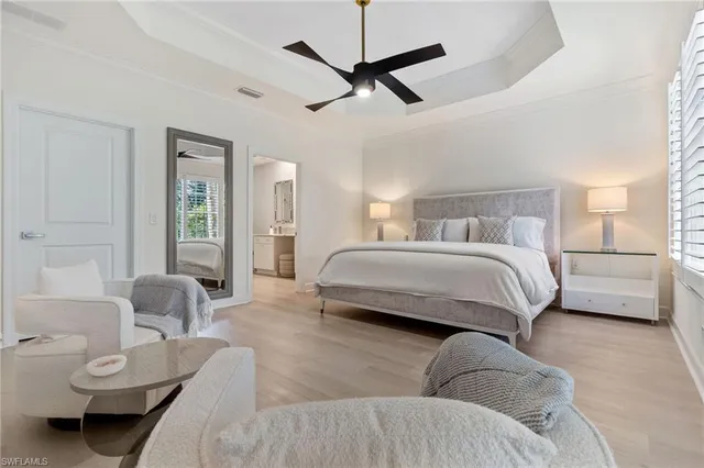 a bedroom with a bed couches and a table