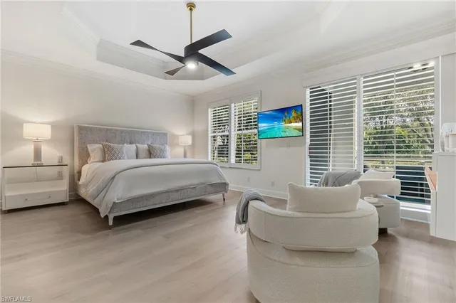 a bedroom with a bed couch and window