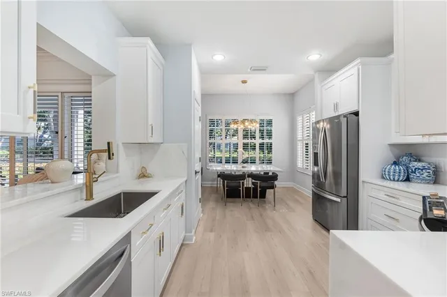 a kitchen with refrigerator cabinets and wooden floor