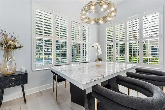a view of a dining room with furniture and a potted plant