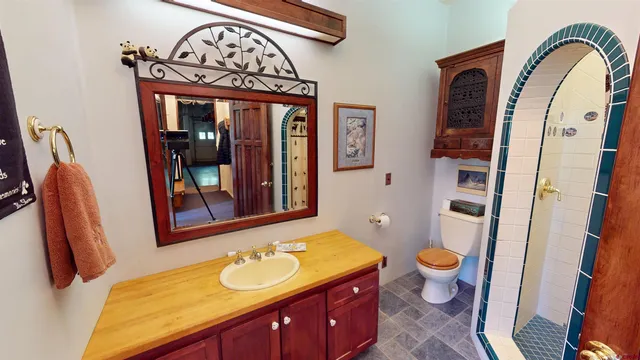 a bathroom with a toilet sink and mirror