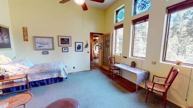 a bedroom with furniture and a large window