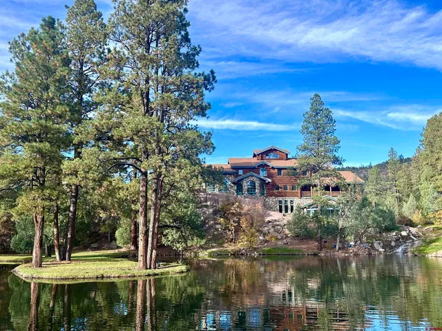 a balcony with lots of green space houses and lake view