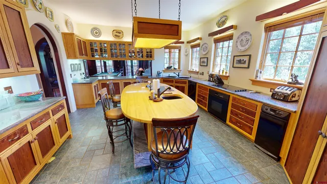a dining room with furniture and a floor to ceiling window