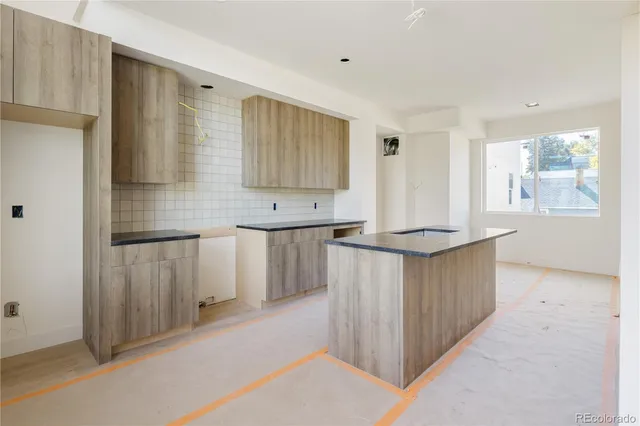 a kitchen with kitchen island cabinets and wooden floor