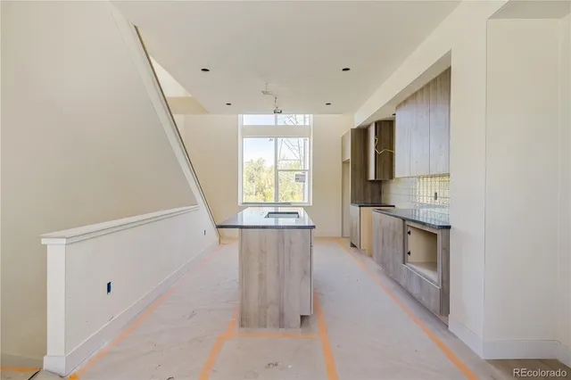 a kitchen with stainless steel appliances a refrigerator and a stove top oven