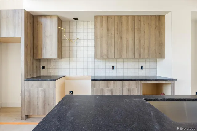 a view of kitchen with sink and cabinets