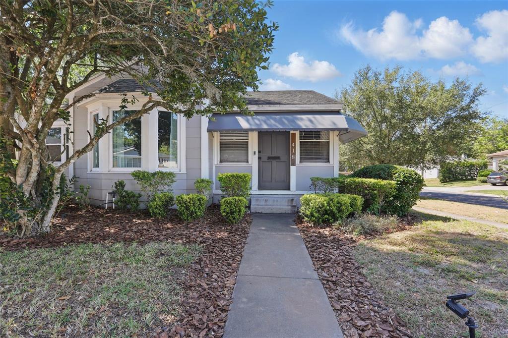 a front view of house with yard and green space