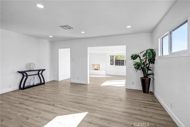 a view of a livingroom with wooden floor and a staircase