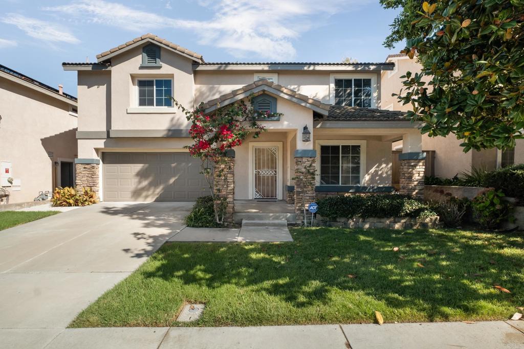 a view of house with a yard and garden