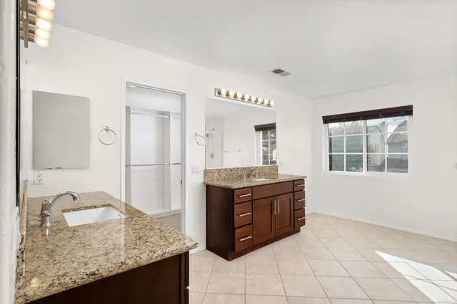a kitchen with granite countertop a sink and a stove