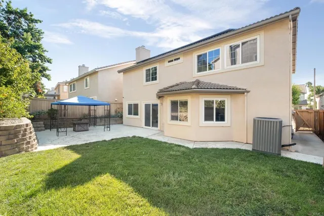 a front view of a house with a garden and yard
