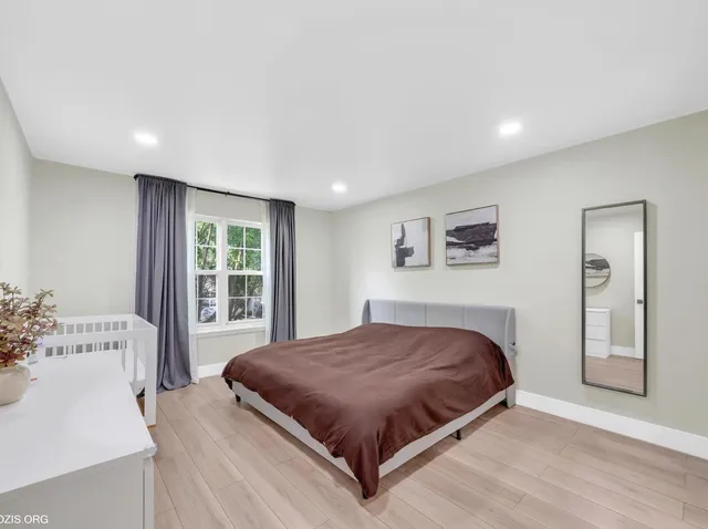 a bedroom with a large bed and a window