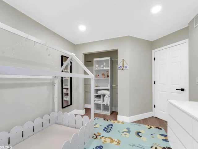 a spacious bedroom with a bed and a window