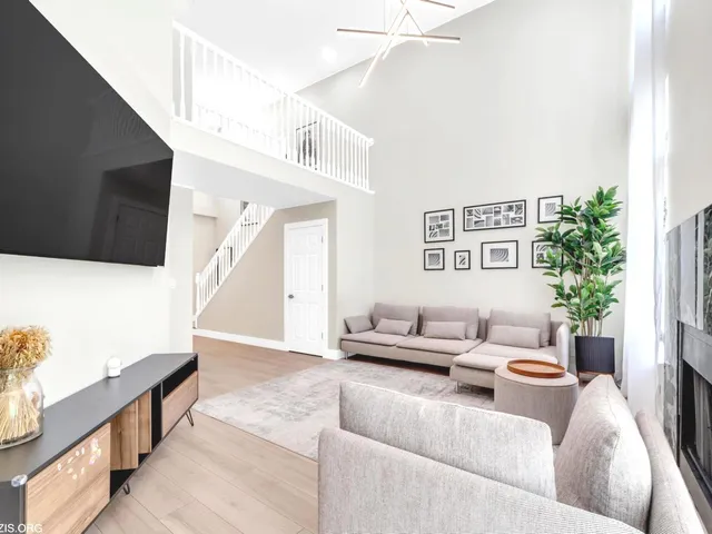 a living room with furniture and a potted plant