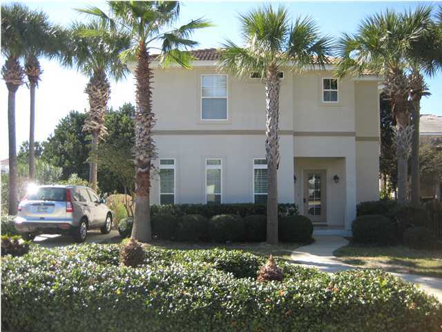 93 Mantero Way Destin, FL 32541 - Photo 20 of 21 a front view of a house with a yard and potted plants