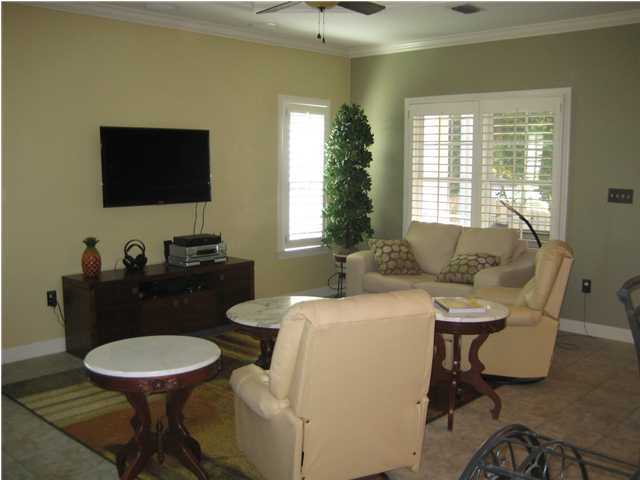 93 Mantero Way Destin, FL 32541 - Photo 3 of 21 a living room with furniture a flat screen tv and a window