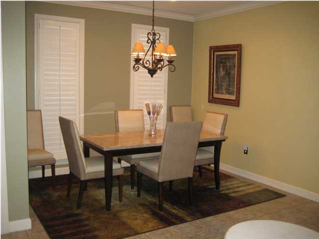 93 Mantero Way Destin, FL 32541 - Photo 4 of 21 a view of a dining room with furniture wooden floor and a chandelier