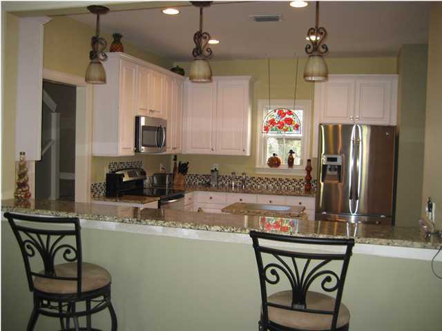 93 Mantero Way Destin, FL 32541 - Photo 6 of 21 a kitchen with stainless steel appliances granite countertop a sink refrigerator and cabinets