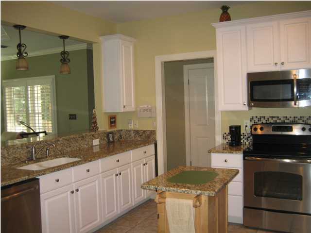 93 Mantero Way Destin, FL 32541 - Photo 8 of 21 a kitchen with granite countertop white cabinets and stainless steel appliances