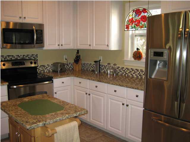 93 Mantero Way Destin, FL 32541 - Photo 9 of 21 a kitchen with stainless steel appliances granite countertop a refrigerator stove and sink